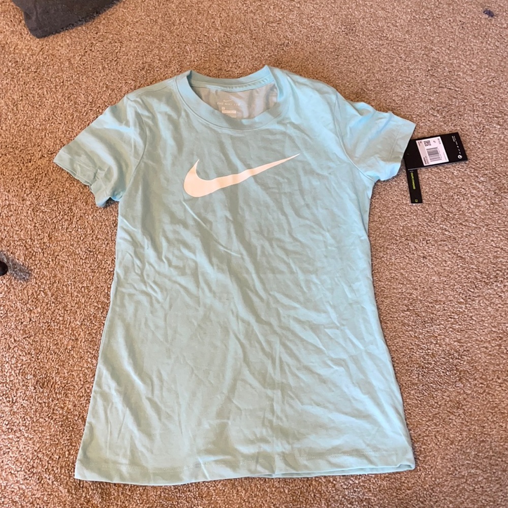 light blue nike tee with white nike symbol in the front